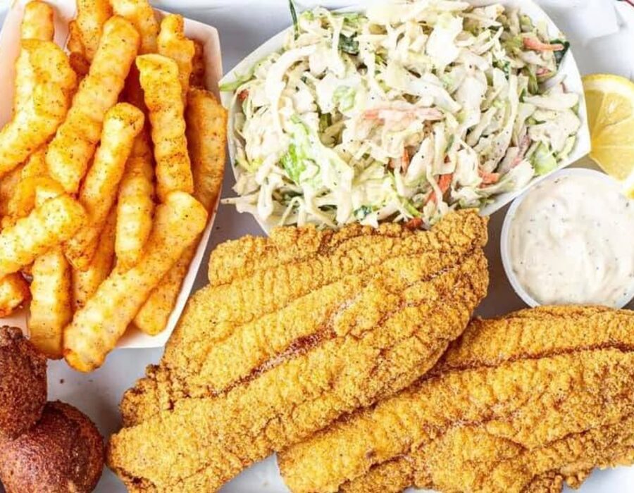 A fried catfish platter with coleslaw and seasoned fries at Nana's Taste & See